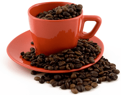 A picture of a coffee cup filled with coffee beans - the ultimate magic beans for improving tech copywriting and creativity